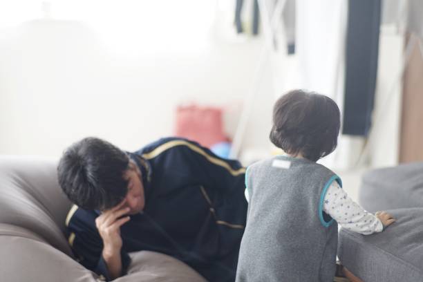 istock Happy father playing with his son at home 1198753689