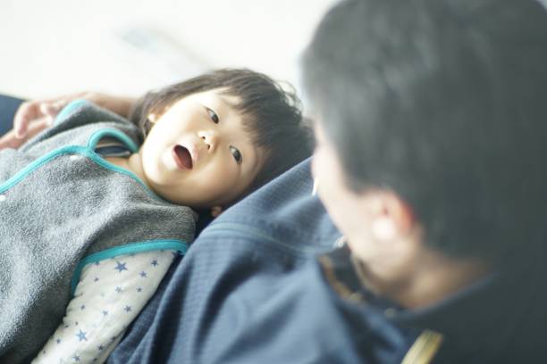 istock Happy father playing with his son at home 1198754977