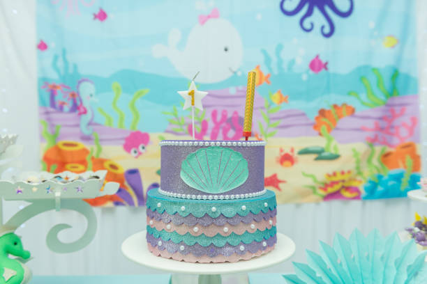 istock Cake table overview decorated with the seabed theme. Children's party with octopus, seahorse, oysters, corals and colorful balloons. Party and fun concept. 1198756049