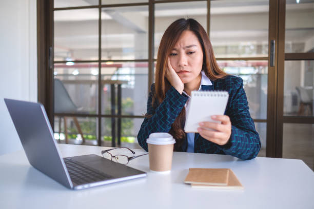 istock Businesswoman get stressed while working and looking at document 1198757759