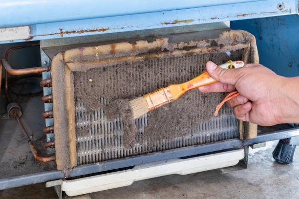 istock A man's hands held a brush to clean the dirty condensing unit. 1198758531