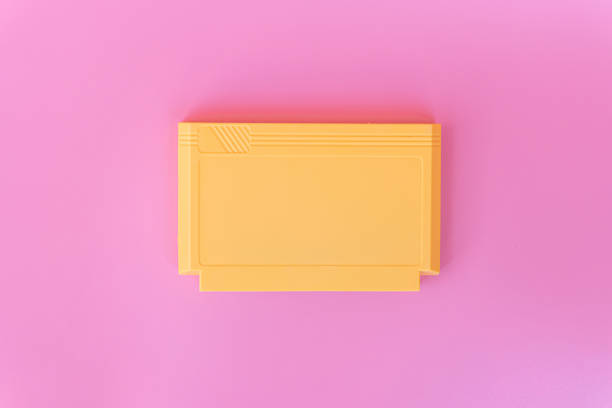 8 bit game cartridge  for retro game console on pink background. Minimal concept.