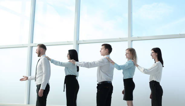 istock professional business team standing near the office window 1198758546