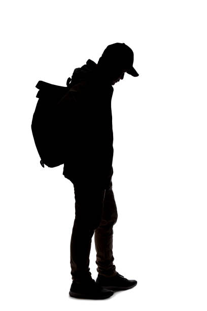 istock Silhouette of a Man Hiking with a Backpack 1198760199