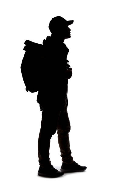 istock Silhouette of a Man Hiking with a Backpack 1198760201