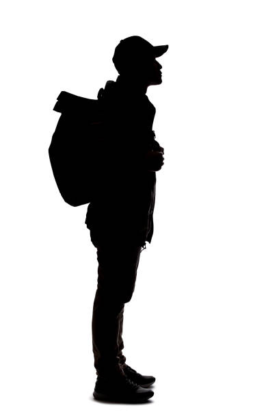istock Silhouette of a Man Hiking with a Backpack 1198760202