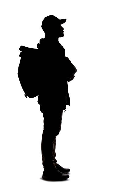 istock Silhouette of a Man Hiking with a Backpack 1198760210