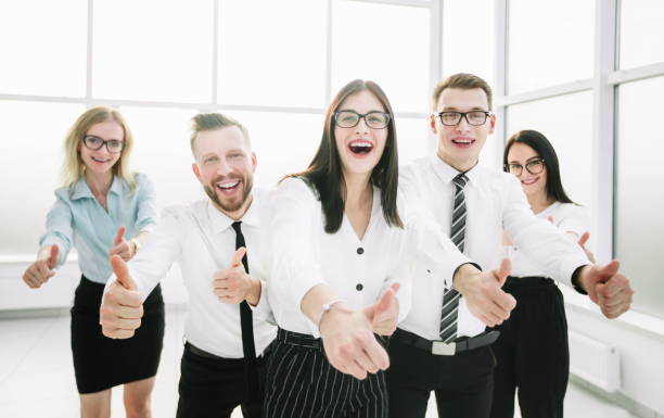 istock happy business team showing their thumbs up 1198761989