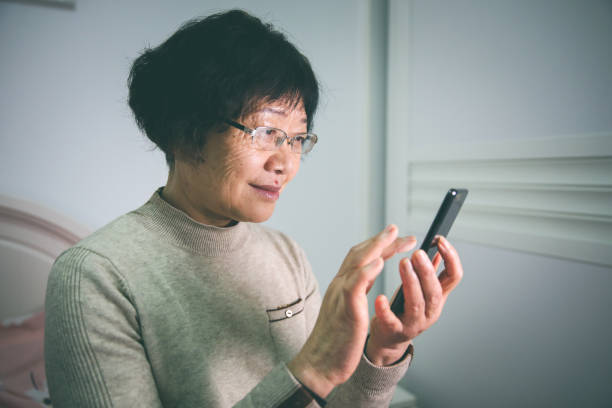 istock Senior Women using phone in bedroom 1198762099