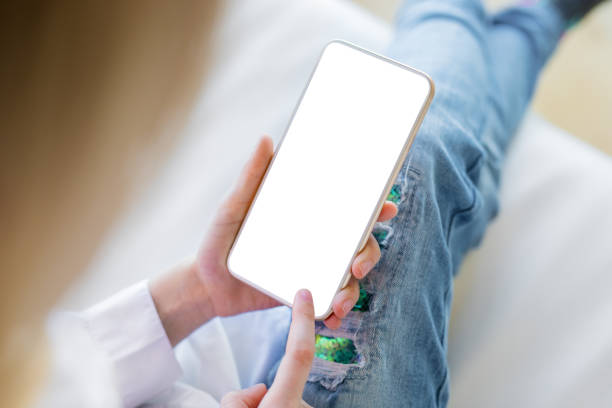 istock Girl using mobile phone with empty screen, mockup for your own design 1198762645