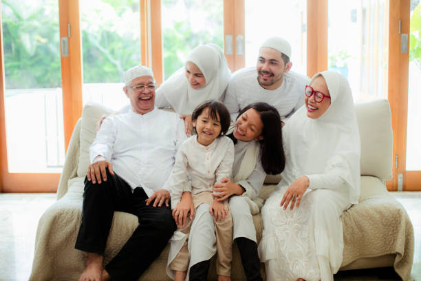 Family line up and taking parent blessing during Eidul Fitri Family blessing during raya celebration eid ul fitr photos stock pictures, royalty-free photos & images