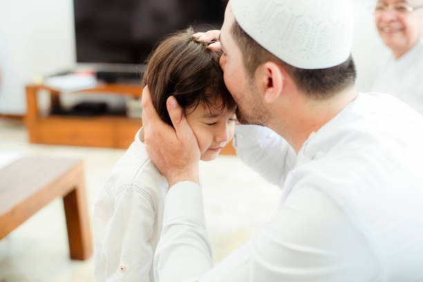 istock Family line up and taking parent blessing during Eidul Fitri 1198764050