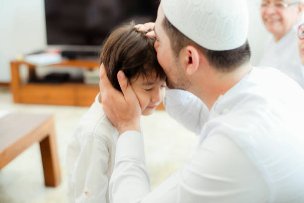 istock Family line up and taking parent blessing during Eidul Fitri 1198764652