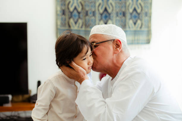 istock Family line up and taking parent blessing during Eidul Fitri 1198764718