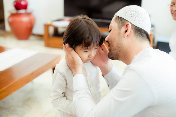 istock Family line up and taking parent blessing during Eidul Fitri 1198764751