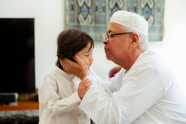 istock Family line up and taking parent blessing during Eidul Fitri 1198765462