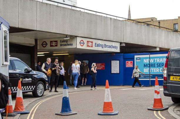Ealing Broadway Station entrance London, UK - June 22, 2019: Passengers at the truly unappealing entrance to Ealing Broadway Station in West London. Both mainline and underground services use this busy station which is being redeveloped to accommodate Crossrail, eanling stock pictures, royalty-free photos & images