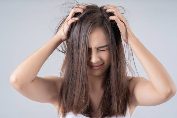 Asian woman. She is shocked at the damaged hair. stock photo