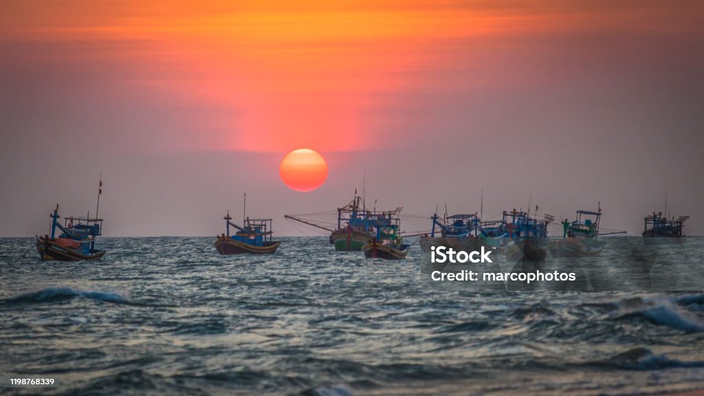 Sunset The sun sets on fishing boats Backgrounds Stock Photo