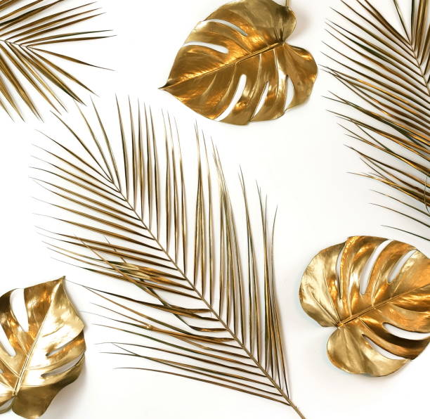 istock Gold palm and monstera leaves plant pattern isolated on a white background. top view. copy space. abstract. 1198769003