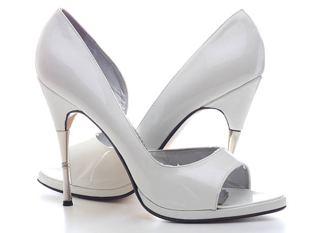 Closeup of a pair of white high heel womens shoes isolated on white background