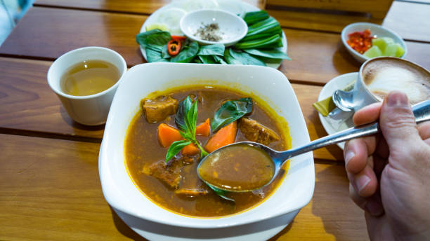 istock Vietnamese beef stew isolated in the table with coffee and vegetables. 1198774352
