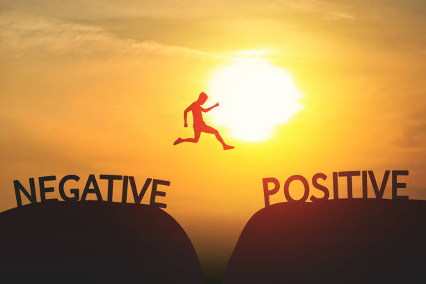 istock A Man jump through the gap between Negative to Positive on sunset. 1198776084