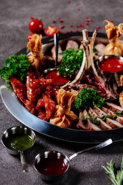 istock Mixed grilled meat platter. Assorted delicious grilled meat with vegetable. 1198776111