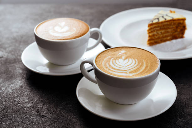 istock two cups of coffee on black stone background 1198776182