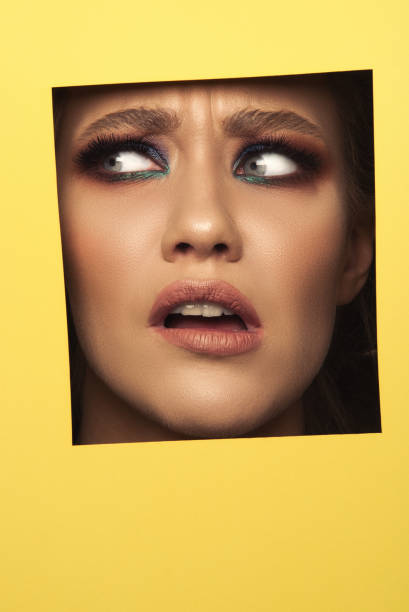 istock Confused woman... hiding behind square shape 1198776283
