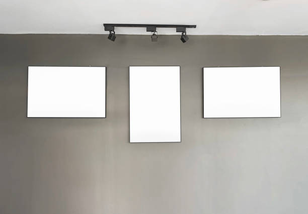 istock Three black wooden frames, hanging on wall. against bricks wall. 1198777026