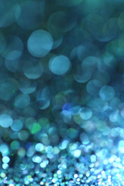 istock Turquoise glitter bokeh background. Turquoise Vibrant background with twinkle lights.blue shiny glitter layout. glitter brilliant mockup 1198780471