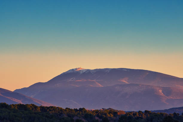 Mirabel-aux-Baronnies, France - December 30, 2019 - View of the sunrise over Mont Ventoux, the highest peak in Provence, located between Vaucluse and Drome in Provence. In the foreground, a first small mountain is visible. In the background, Mont Ventoux and its observatory located at the top are visible.