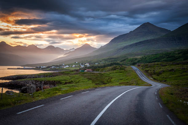 istock Iceland road landscape with clouds and amply field 1198790278