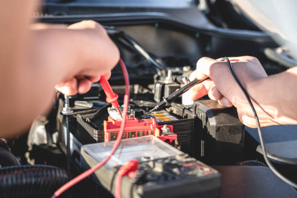 istock Mechanic repairman checking engine automotive in auto repair service and using digital multimeter testing battery to measure various values and analyze, Service and Maintenance car battery check 1198791499