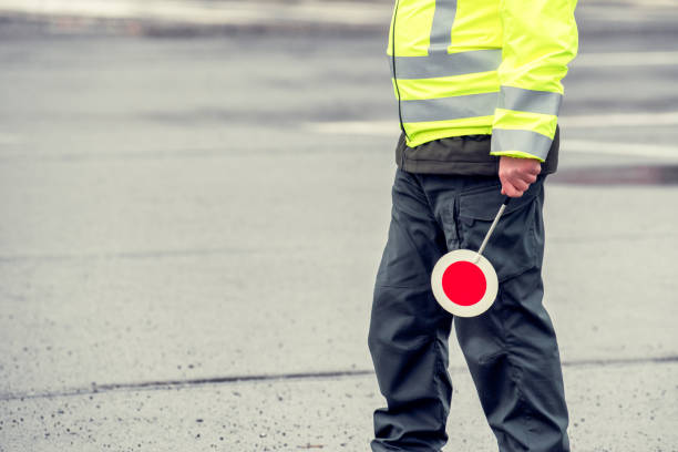 istock Cop in reflective vest with stop sign 1198791529