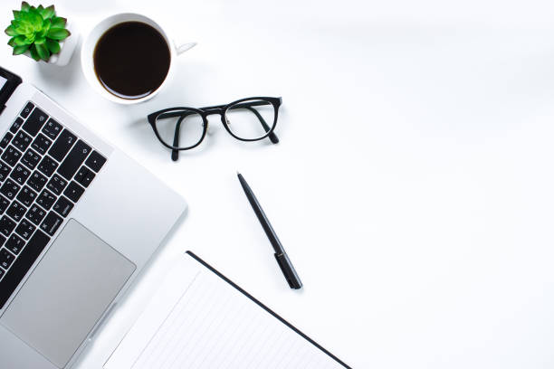 istock Office workplace with text space, White wooden table with laptop and book. Top view. 1198793821