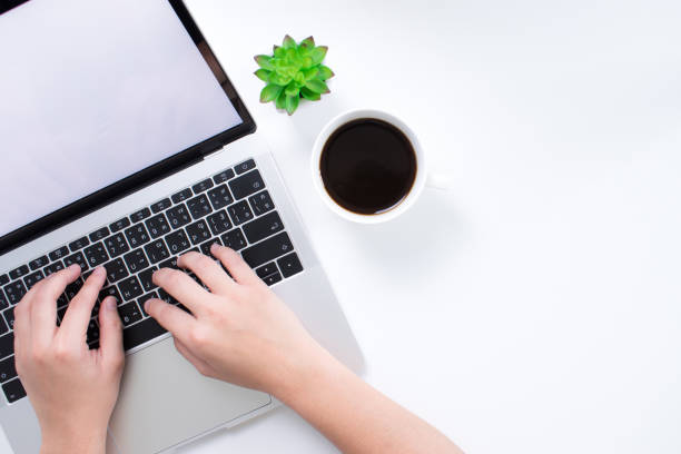 istock A workspace with a laptop on a simple table and a woman's hand is working. With a copy area in the business concept. 1198794284