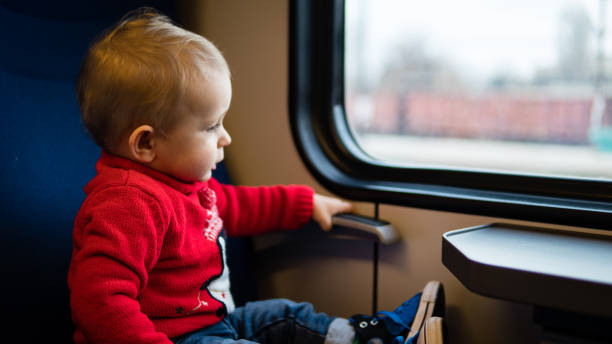 istock Child looking through window of a bus 1198794338