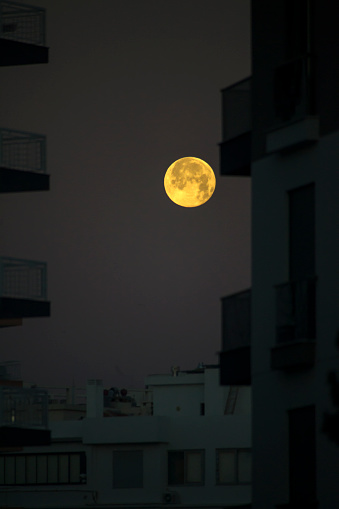 View of Full Moon in Urban Sky