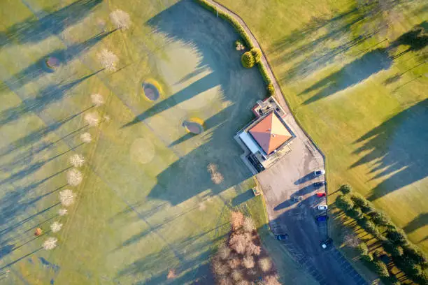 Aerial view of golf course green and clubhouse from above frozen grass in winter at Aboyne Aberdeenshire Scotland uk