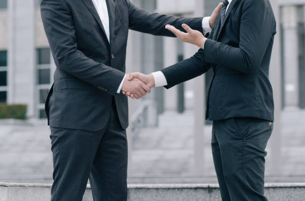 istock Midsection Of Businessmen Shaking Hands 1198800740