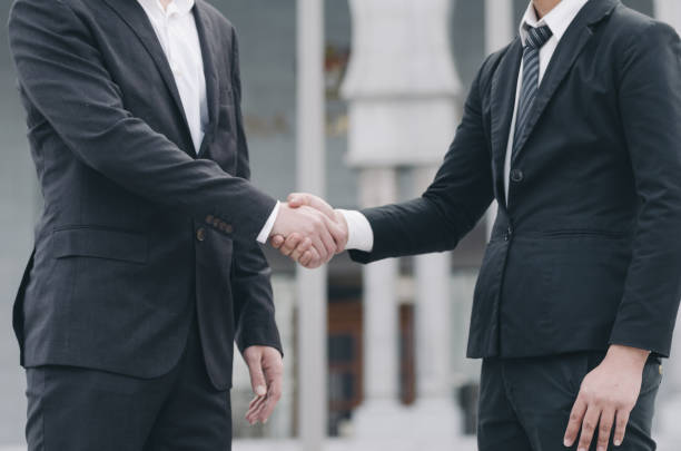 istock Midsection Of Businessmen Shaking Hands 1198804296