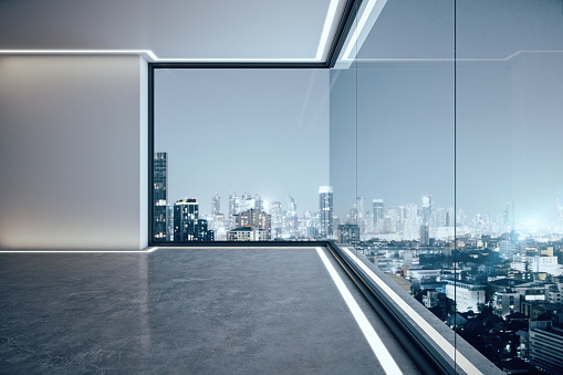 Minimalist empty spacious office interior with illuminated panoramic city view. 3D Rendering