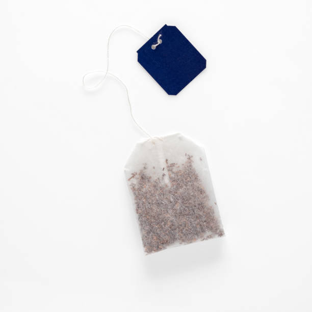 Tea bag in rectangle shape with blue label isolated on white background stock photo
