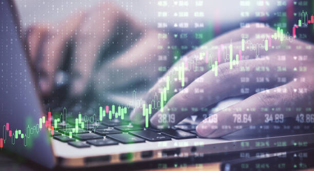 istock Forex chart and financial graphs on digital screen and man typing on laptop.Double exposure. 1198812812