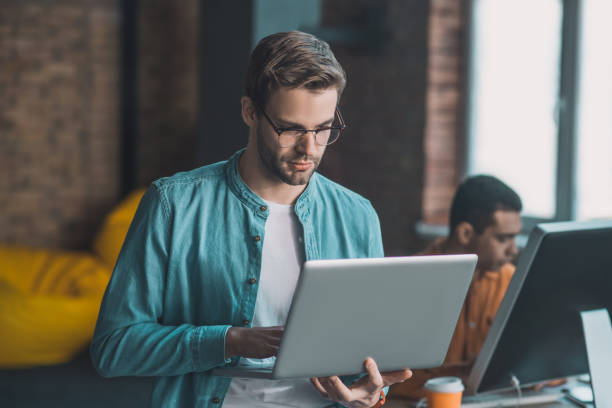 istock Nice good looking man working on his laptop 1198814106