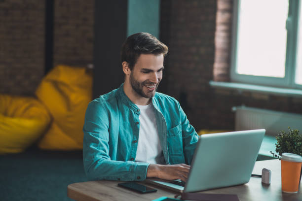istock Happy handsome man working on his laptop 1198814150