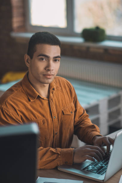 istock Handsome smart man sitting at his workplace 1198814179