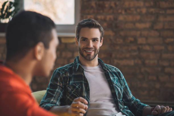istock Joyful happy man smiling to his friend 1198814220